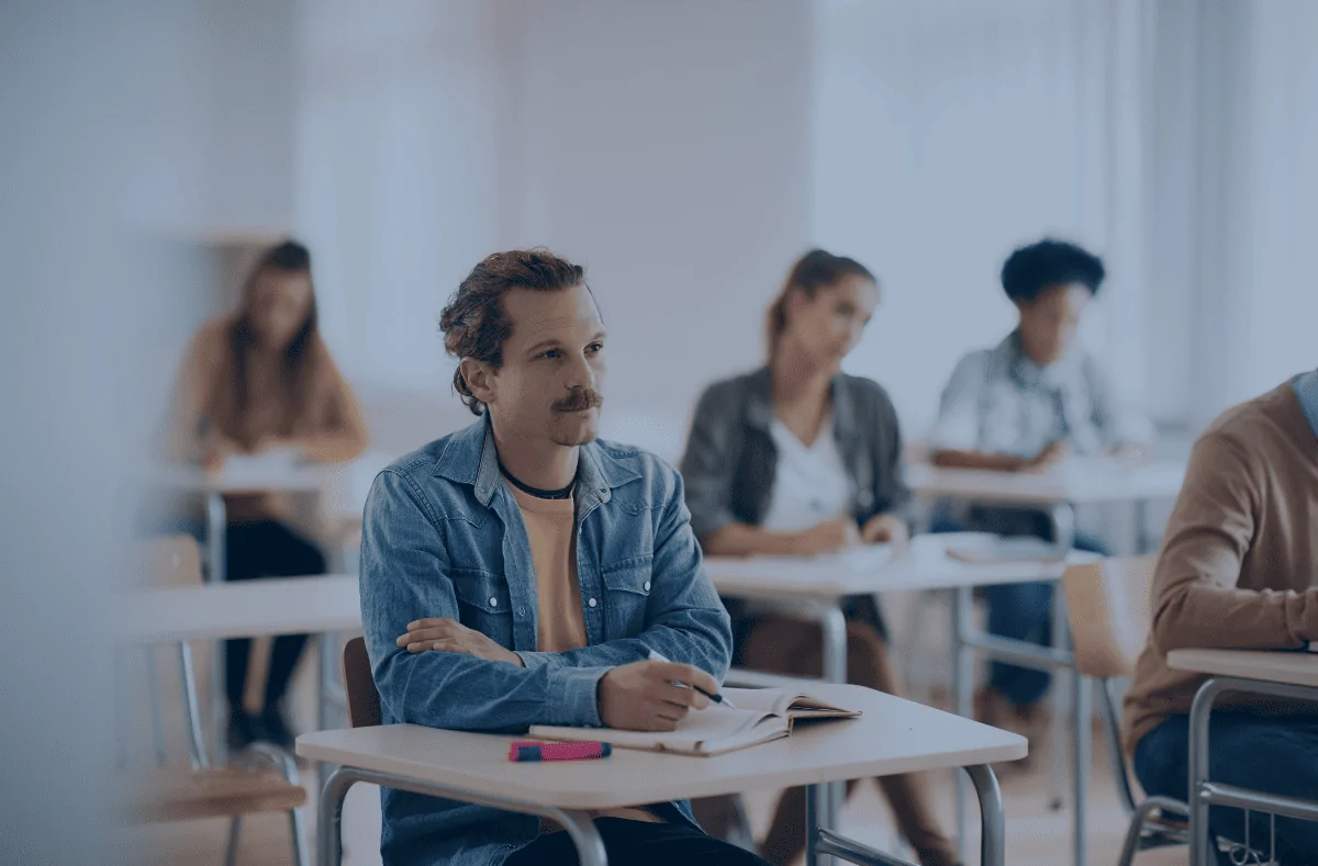Un apprenant effectuant un cours en présentiel dans une salle de classe.